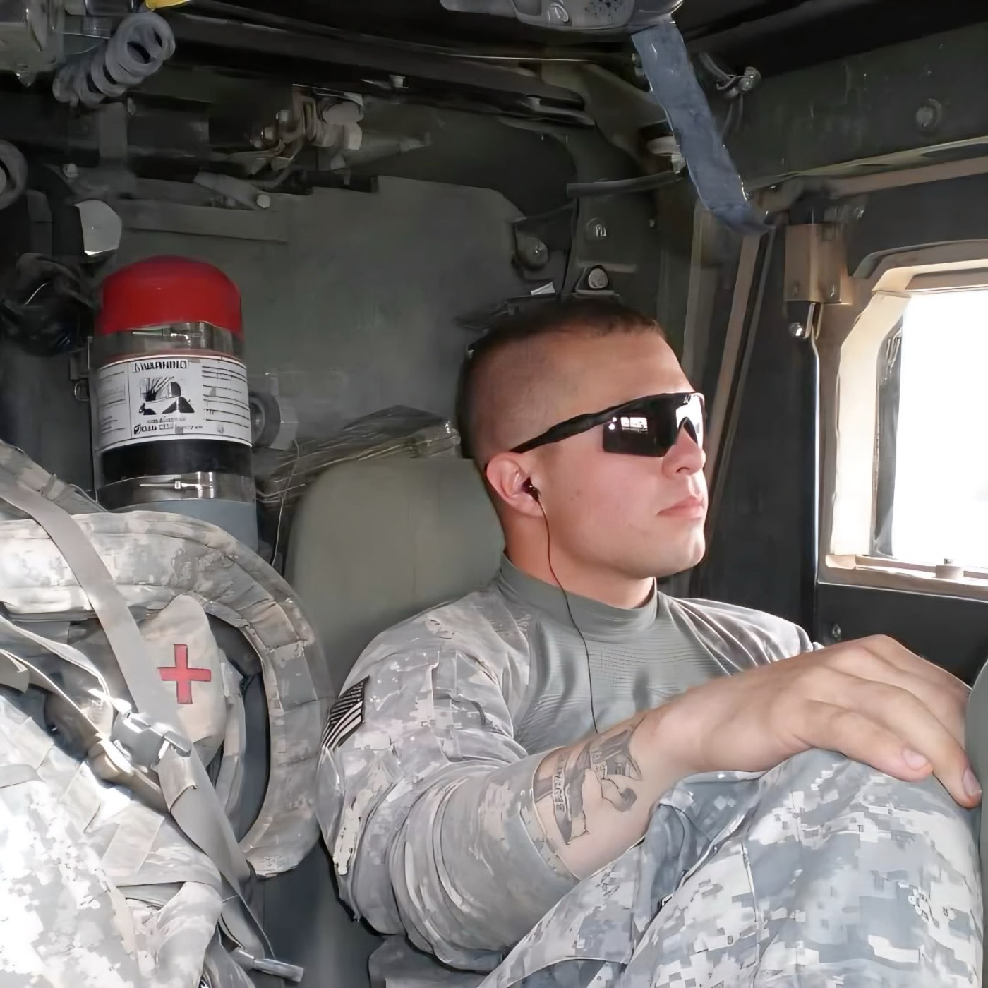 Brian Dimoff in uniform seated inside a military vehicle during deployment