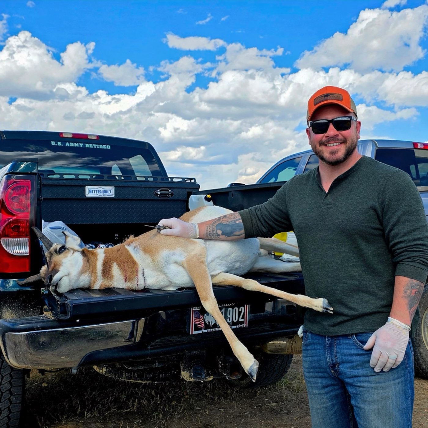 Brian Dimoff standing beside a harvested pronghorn in the bed of his truck